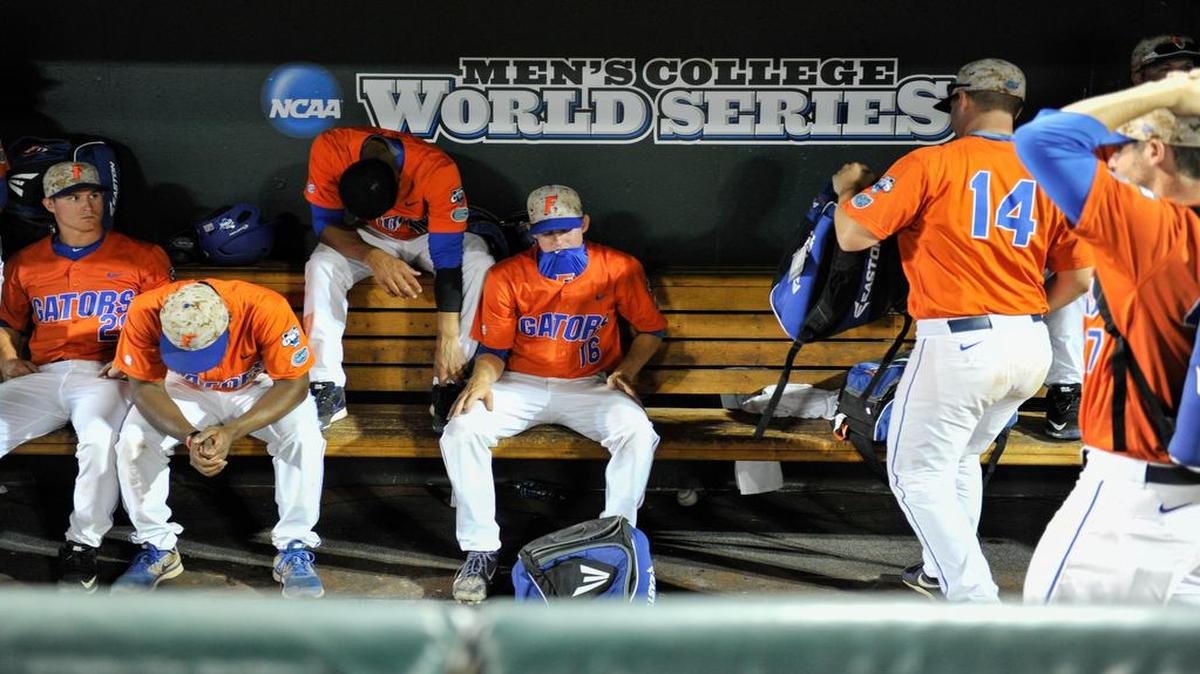 
Florida players, including Tommy Doyle (16) sit in the dugout following an NCAA College World Series baseball elimination game against Virginia in Omaha, Neb., Saturday, June 20, 2015. Virginia won 5-4 and advances to play Vanderbilt in the championship series. 
