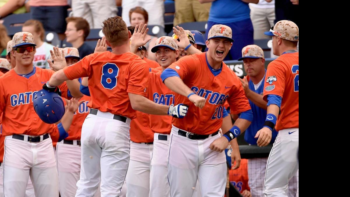 
Florida's Harrison Bader (8) celebrates his solo home run against Miami in the first inning in the College World Series in Omaha, Neb., Wednesday, June 17, 2015.

