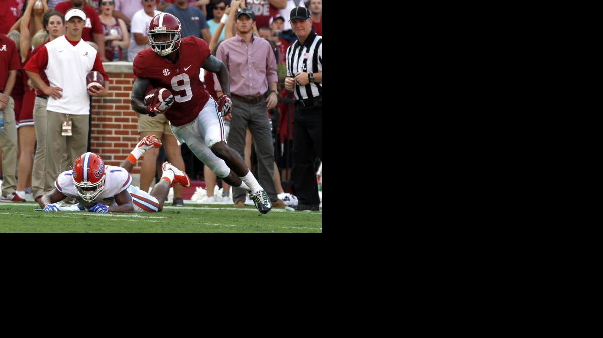 
Alabama wide receiver Amari Cooper (9) catches a pass as Florida defensive back Vernon Hargreaves, III (1) falls down during the second half of an NCAA college football game on Saturday, Sept. 20, 2014, in Tuscaloosa, Ala. 
