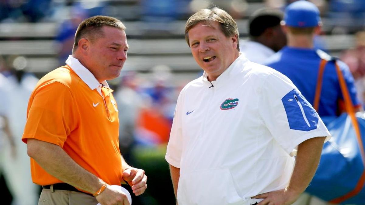 Tennessee head coach Butch Jones, left, and Florida head coach Jim McElwain chat at midfield before an NCAA college football game in Gainesville, Fla. Jones is in his fourth season on the job and believes his Volunteers have never faced a defense quite as good as the one Florida brings to Neyland Stadium this weekend.
