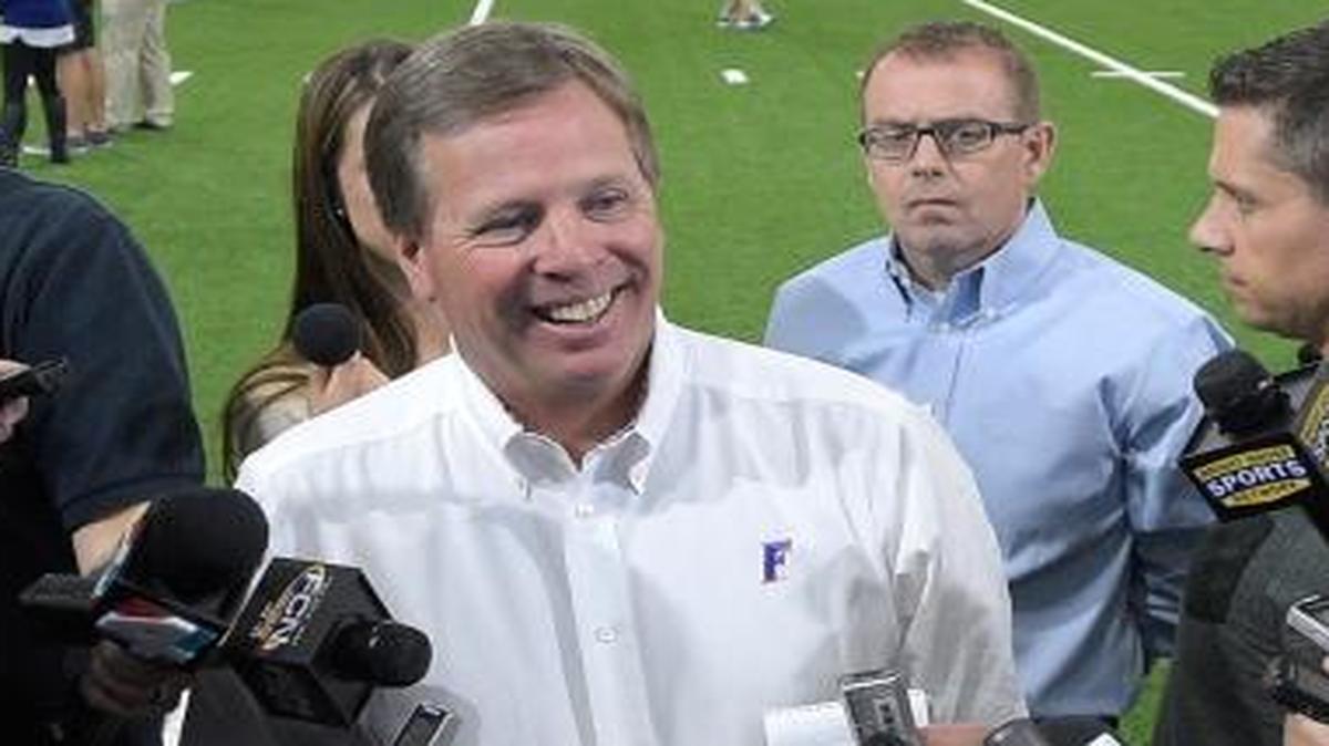 Florida head football coach Jim McElwain, center, answers questions from reporters during Florida's NFL Pro Day in Gainesville, Fla., Tuesday, March 22, 2016.