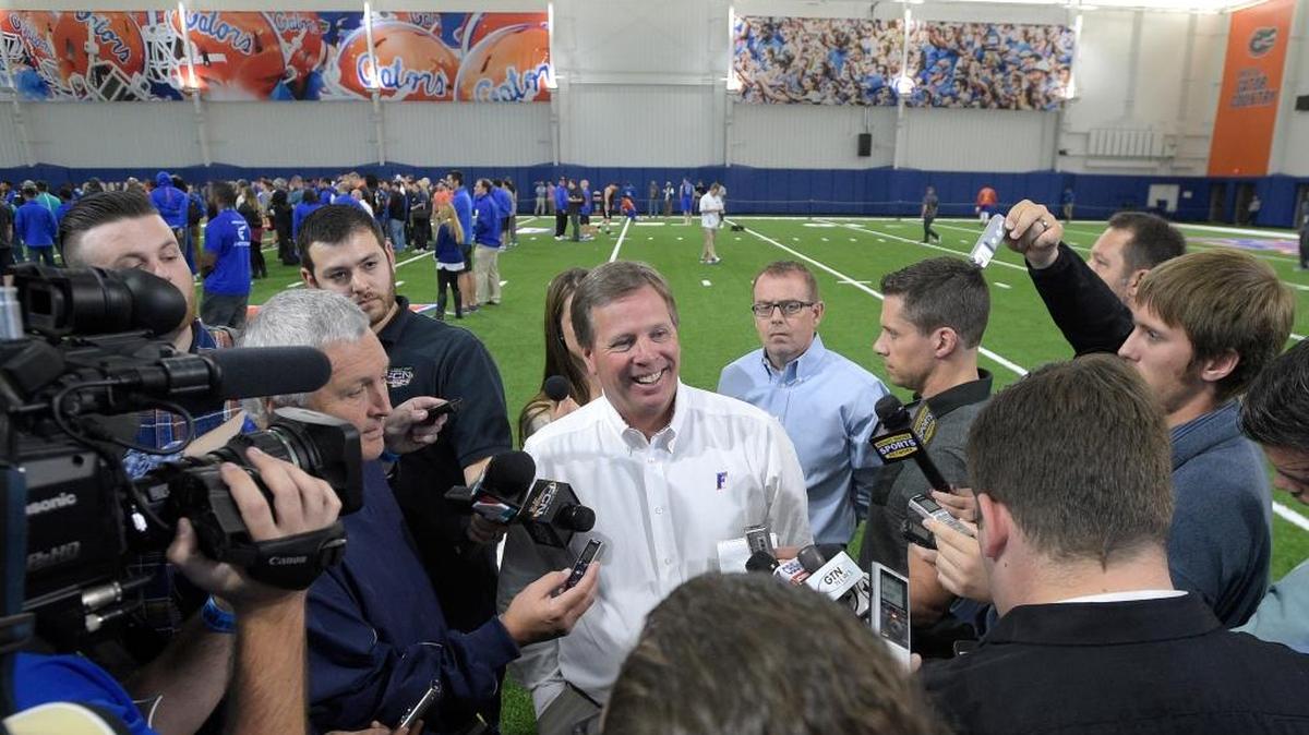 Florida head football coach Jim McElwain, center, answers questions from reporters during Florida's NFL Pro Day in Gainesville, Fla., Tues., March 22, 2016.