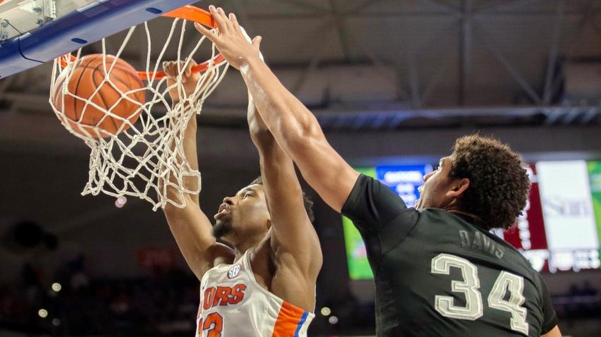 Florida forward Kevarrius Hayes (13) dunks the ball over Texas A&M center Tyler Davis (34) during the first half of an NCAA college basketball game in Gainesville, Fla., Saturday, Feb. 11, 2017.