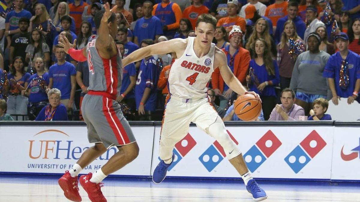Egor Koulechov #4 of the Florida Gators dribbles the ball against Christian Turner #4 of the Gardner Webb Runnin Bulldogs during a NCAA basketball game at the Stephen C. O' Connell Center on Nov. 13, 2017 in Gainesville, Florida.