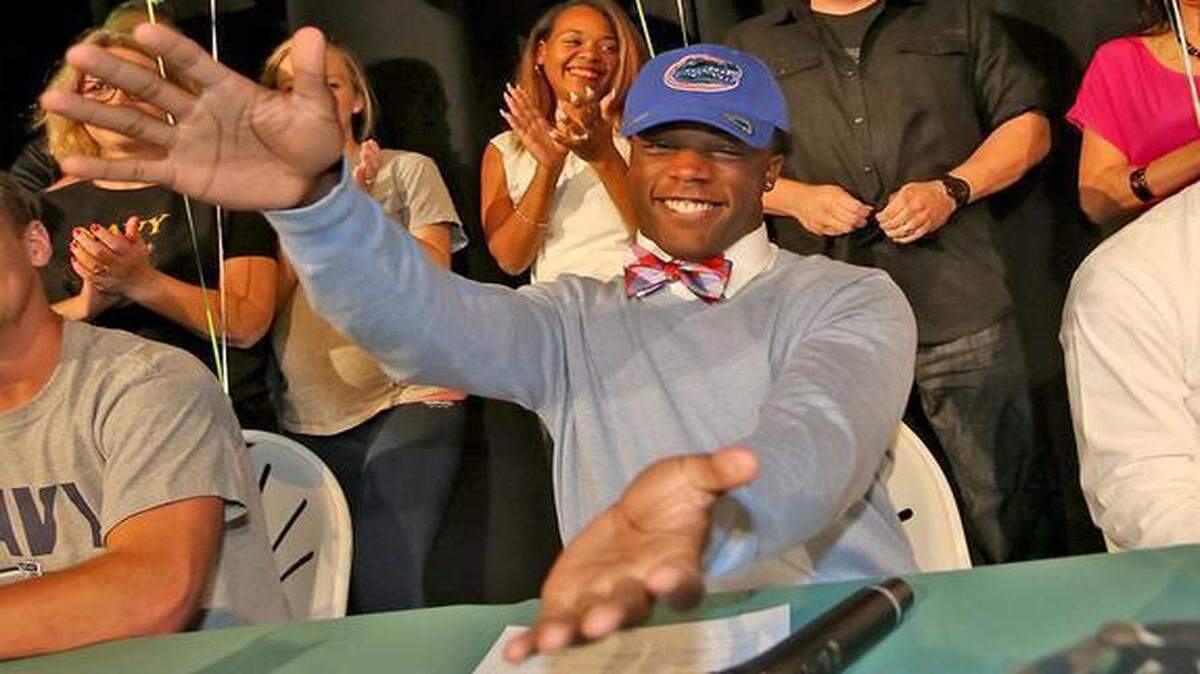 
Westminster Christian running back Jordan Cronkrite does the “Gator Chomp” after signing with the University of Florida on Wednesday, Feb. 4, 2015. 
