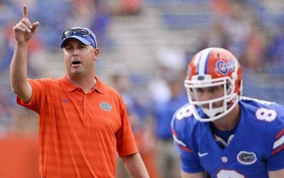
Florida's offensive coordinator Kurt Roper, left, works with quarterback Skyler Mornhinweg (8) in Gainesville, Fla., Saturday, Aug. 30, 2014. 
