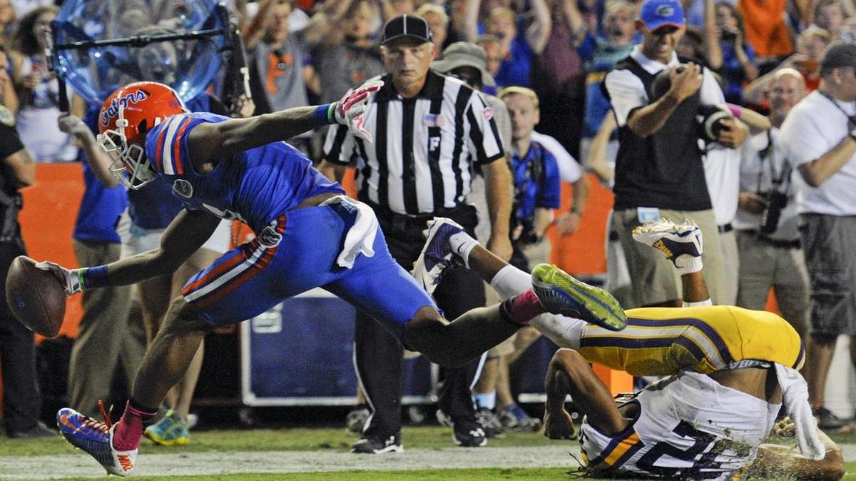 
Demarcus Robinson, left, scores a touchdown past LSU cornerback Jalen Collins (32) on an 11-yard pass play during the second half of an NCAA college football game in Gainesville, Fla., Saturday, Oct. 11, 2014. (AP Photo/Phil Sandlin)
