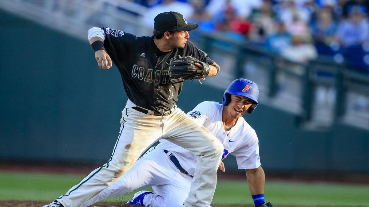 Coastal Carolina shortstop Michael Paez throws to first after forcing out Florida’s Jonathan India to complete a double play during the second inning of Sunday’s game.
