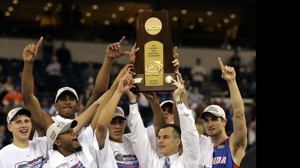 
Florida players celebrate as head coach Billy Donovan holds the trophy aloft after the Gators beat UCLA 73-57 in the national championship game in Indianapolis on April 3, 2006. 
