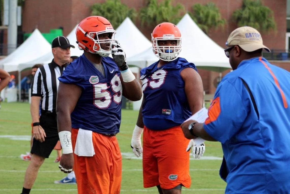 Florida center TJ McCoy, left, goes through drills during practice Fri., Aug. 4, 2017.