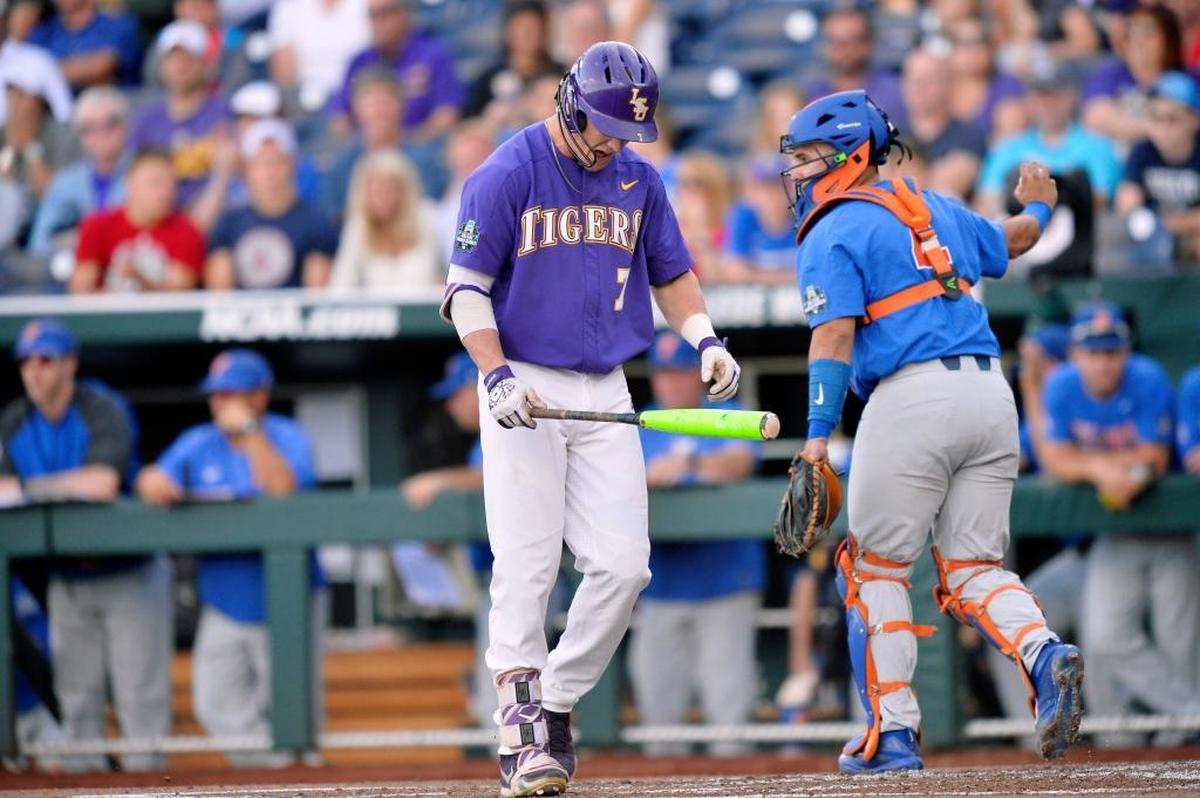 LSU's Greg Deichmann (7) reacts after striking out to end the first inning of Game 1 of the NCAA College World Series baseball finals against Florida in Omaha, Neb., Mon., June 26, 2017.