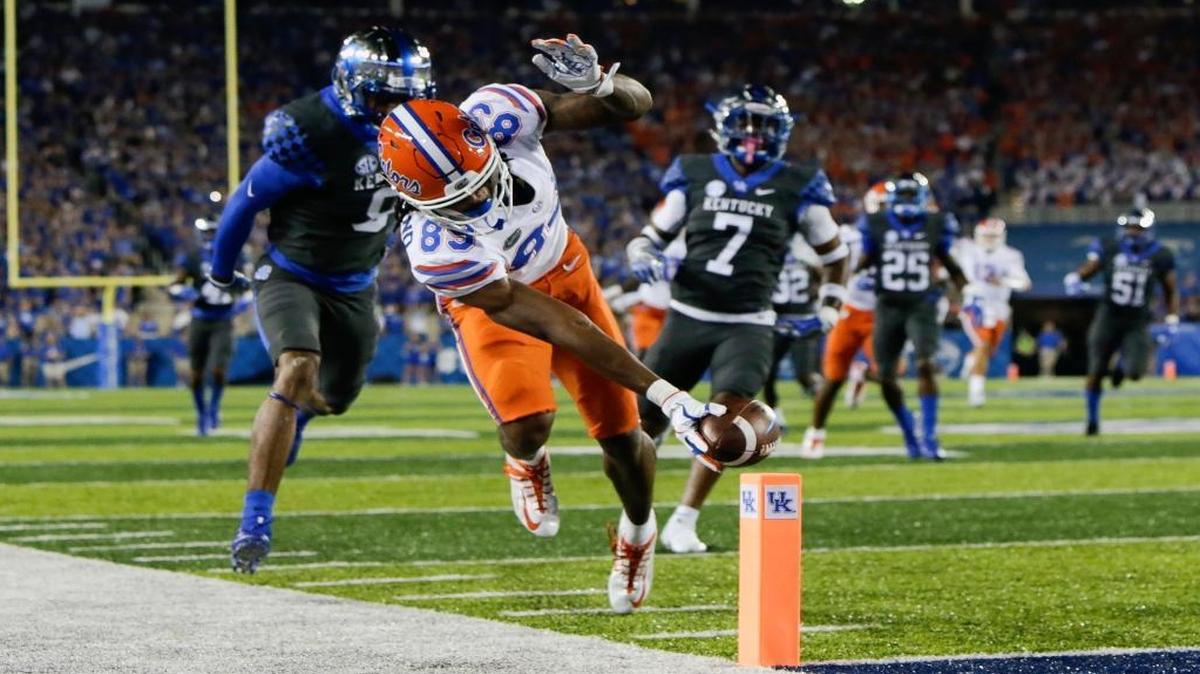 Florida wide receiver Tyrie Cleveland reaches for the goal line in front of Kentucky cornerback Derrick Baity, left, and safety Mike Edwards to score a touchdown during the first half of an NCAA college football game Saturday, Sept. 23, 2017, in Lexington, Ky.