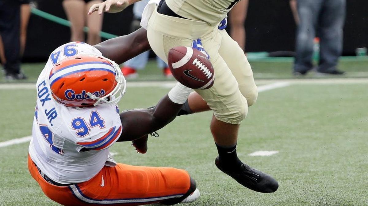 Vanderbilt punter Sam Loy (19) fumbles the ball as he is hit by Florida defensive lineman Bryan Cox (94) in the second half of an NCAA college football game Sat., Oct. 1, 2016, in Nashville, Tenn. Florida recovered the ball on the play. Florida won 13-6.
