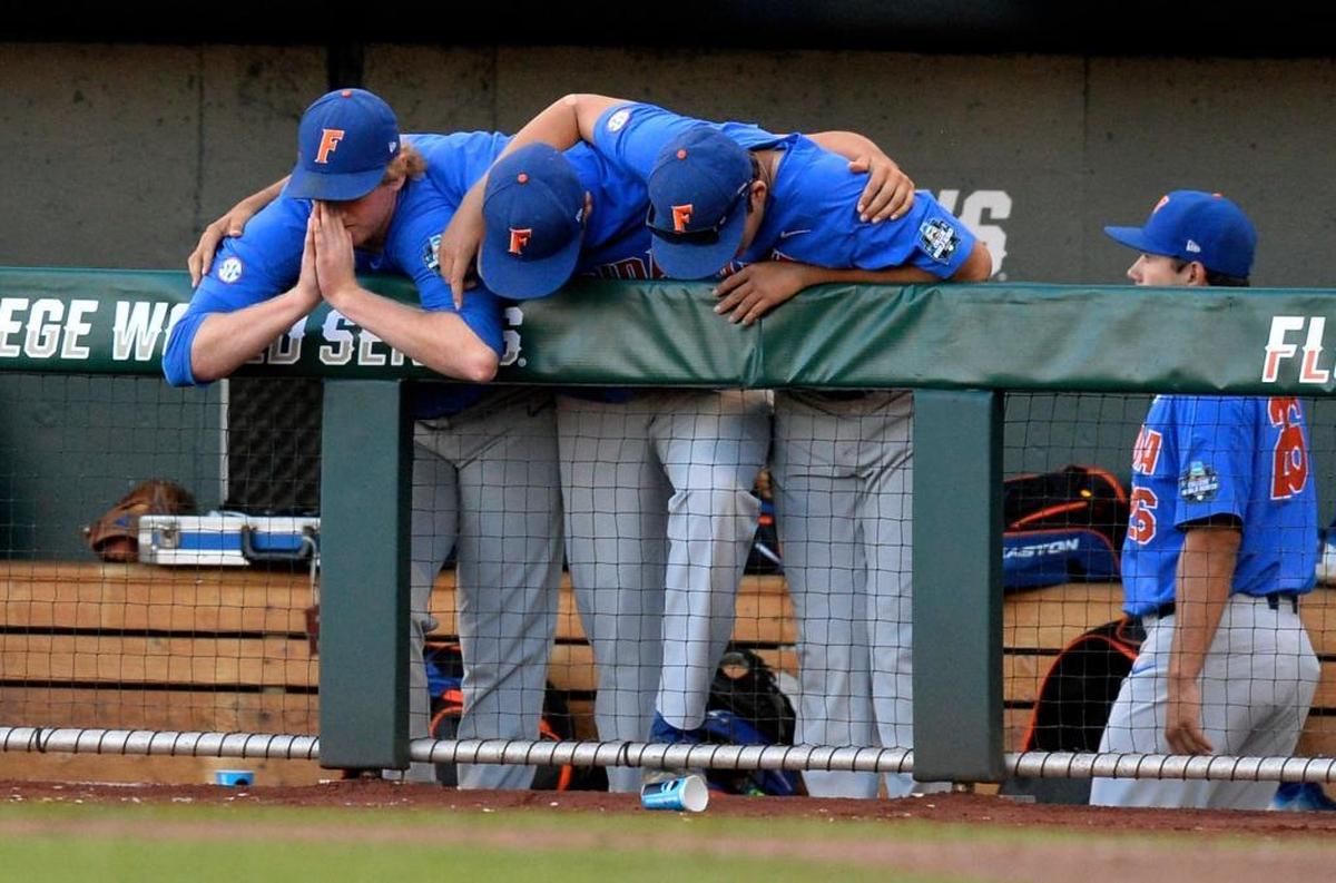 Florida players assume a prayerful posture after their three-run fourth inning of Game 1 of the NCAA College World Series baseball finals in Omaha, Neb., Mon., June 26, 2017.
