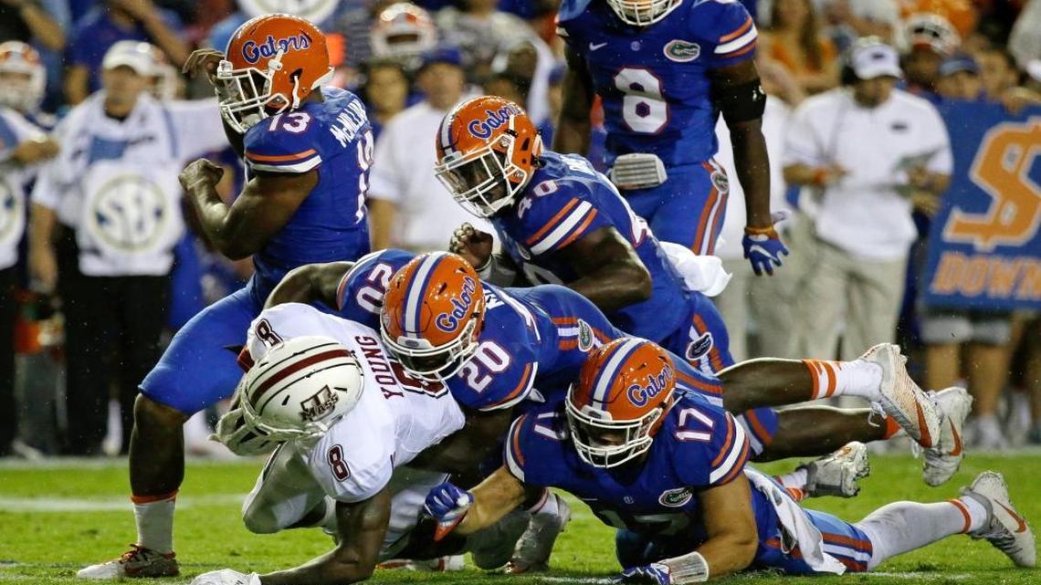Massachusetts running back Marquis Young (8) is stopped by the Florida defense including defensive back Marcus Maye (20) and defensive lineman Jordan Sherit (17) during the first half of an NCAA college football game, Sat., Sept. 3, 2016, in Gainesville, Fla.