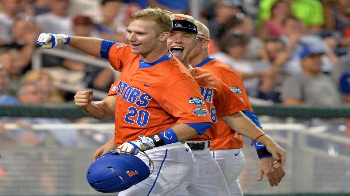
Florida's Peter Alonso (20) celebrates his two-run home run with Harrison Bader (8) in the seventh inning of an NCAA College World Series baseball elimination game against Miami at TD Ameritrade Park in Omaha, Neb., Wednesday, June 17, 2015.
