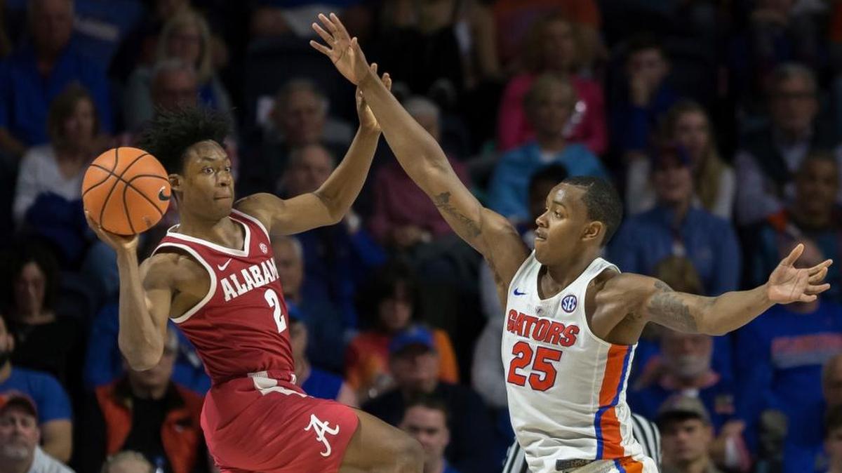 Alabama guard Collin Sexton (2) looks to pass around Florida forward Keith Stone (25) during the second half of an NCAA college basketball game in Gainesville, Fla., Saturday, Feb. 3, 2018.