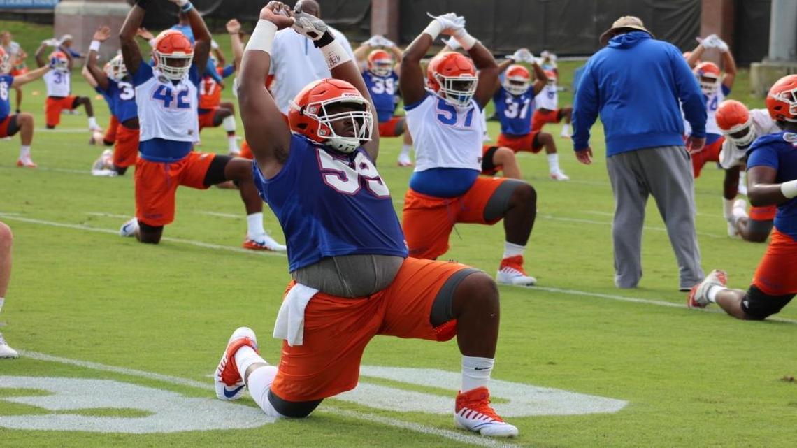 Florida center TJ McCoy stretches during practice Fri., Aug. 4, 2017.