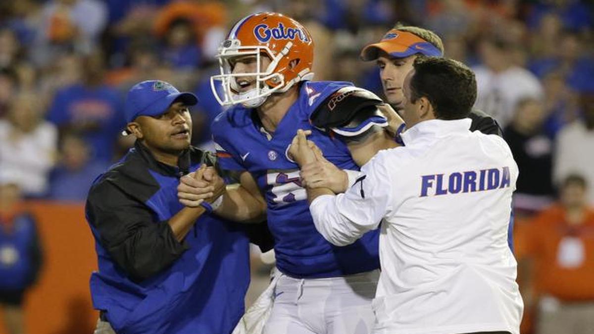 
Florida quarterback Jeff Driskel, center, is helped off the field after he was injured during the first half of an NCAA college football game against Missouri in Gainesville, Fla., Saturday, Oct. 18, 2014. 
