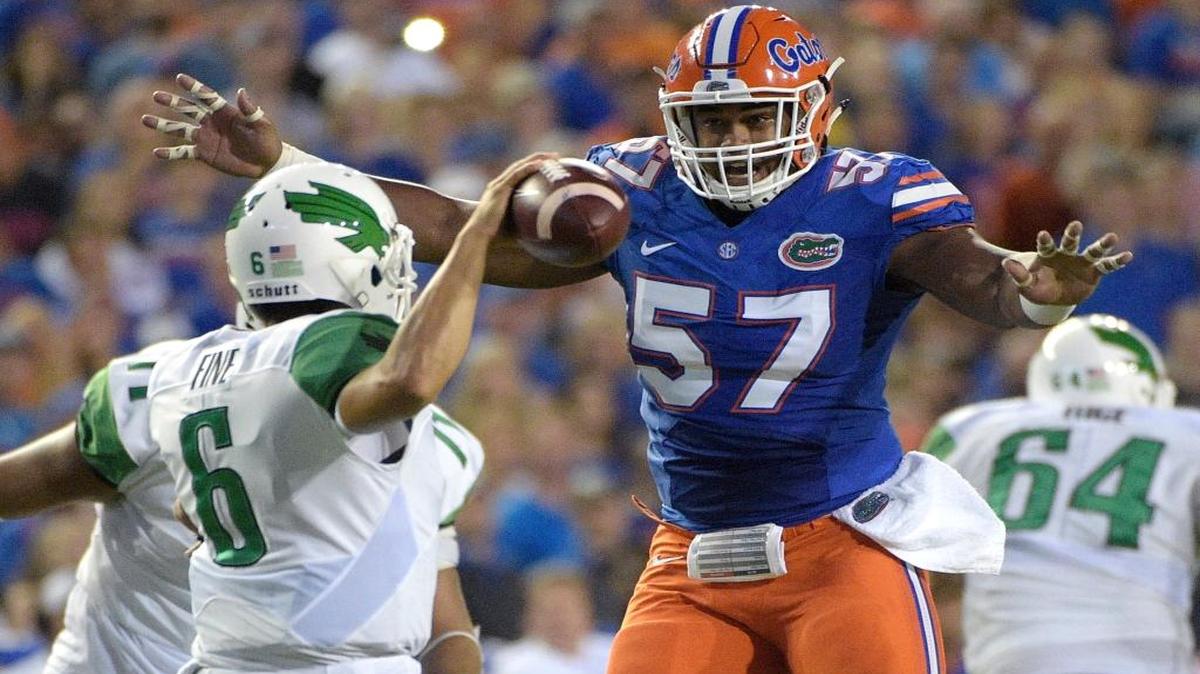 Florida defensive lineman Caleb Brantley (57) pressures North Texas quarterback Mason Fine during the first half of Saturday’s game, during which Brantley sacked Fine in the end zone for a safety.