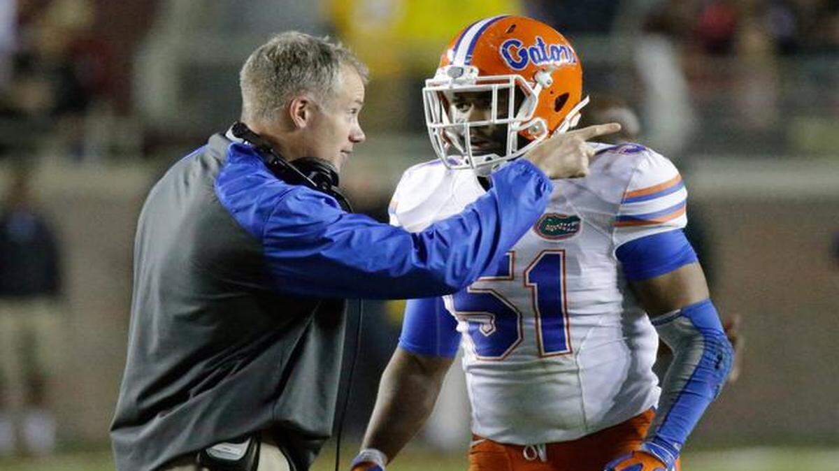 
Bowl-game preparations: UF interim coach D.J. Durkin, talking with linebacker Michael Taylor, said, ‘Everyone wants to work with people that are motivated.’ 
