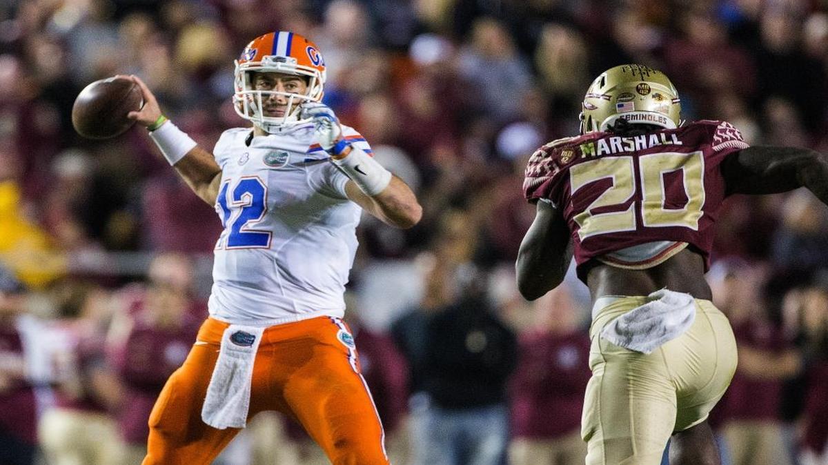 Florida quarterback Austin Appleby passes as Florida State's Trey Marshall rushes during the first half of an NCAA college football game in Tallahassee, Fla., Sat., Nov. 26, 2016.
