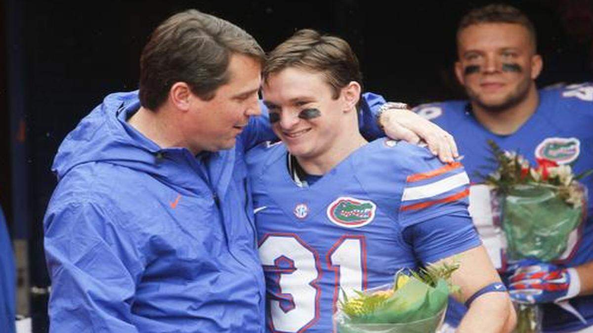 
Will Muschamp, hugging wide receiver Michael McNeely, will coach his final game for UF on Saturday against FSU. 
