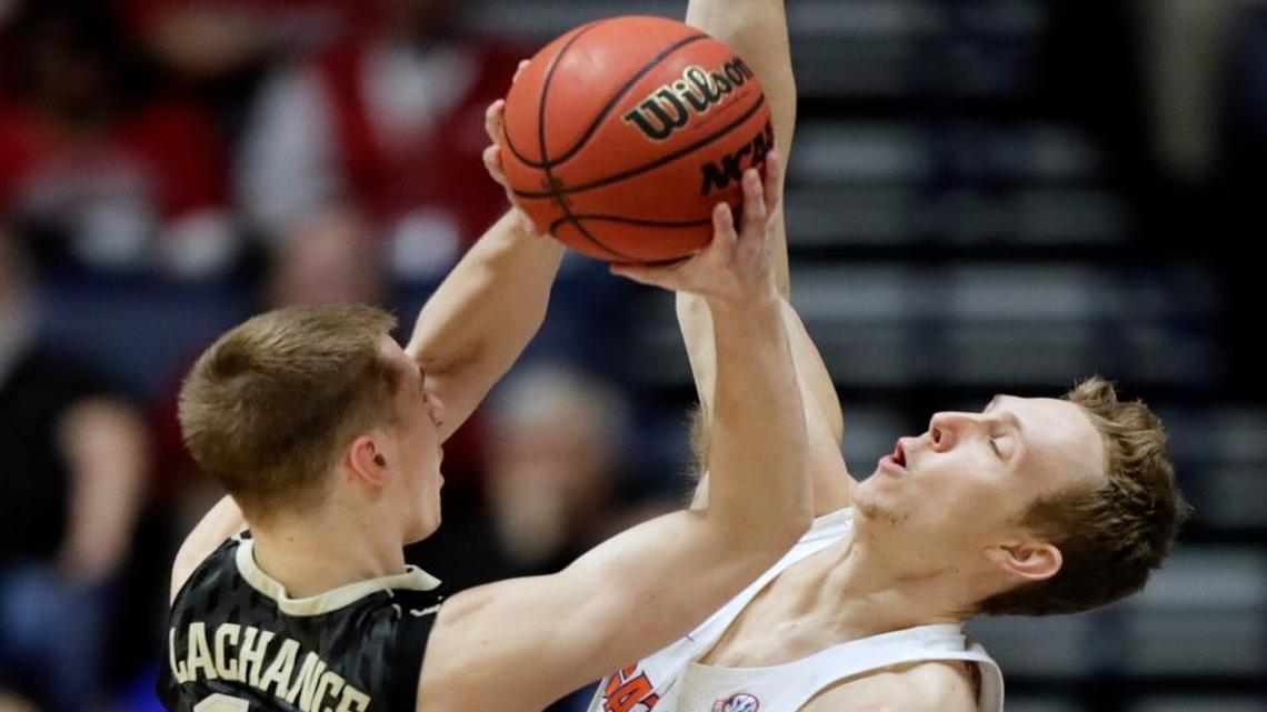 Vanderbilt guard Riley LaChance (13) shoots against Florida guard Canyon Barry (24) during the first half of an NCAA college basketball game at the Southeastern Conference tournament Friday, March 10, 2017, in Nashville, Tenn.