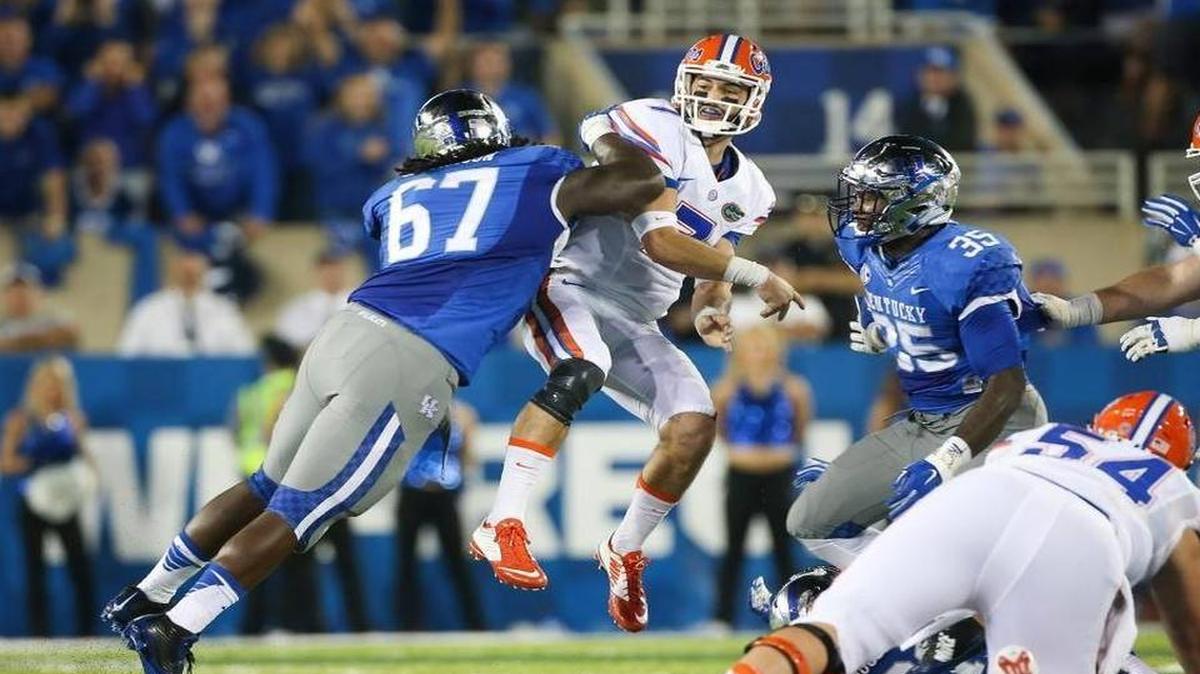 
Florida quarterback Will Grier is hit by Kentucky defensive tackle Cory Johnson, left, after throwing a pass during the first half of an NCAA college football game, Saturday, Sept. 19, 2015, in Lexington, Ky.
