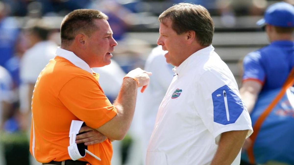 Tennessee head coach Butch Jones, left, and Florida head coach Jim McElwain meet at midfield before an NCAA college football game between Florida and Tennessee in Gainesville, Fla. Two weeks after losing a season opener for the first time in 28 years, the Gators are facing the possibility of starting 0-2 for the first time since 1971 when they host Tennessee on Saturday.