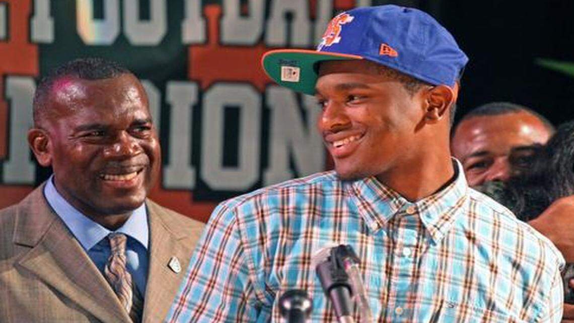 
Treon Harris signs with the University of Florida during National Signing Day at Booker T. Washington on Wednesday, Feb. 5, 2014. At left is his father and then-coach Tim ‘Ice’ Harris Sr.
