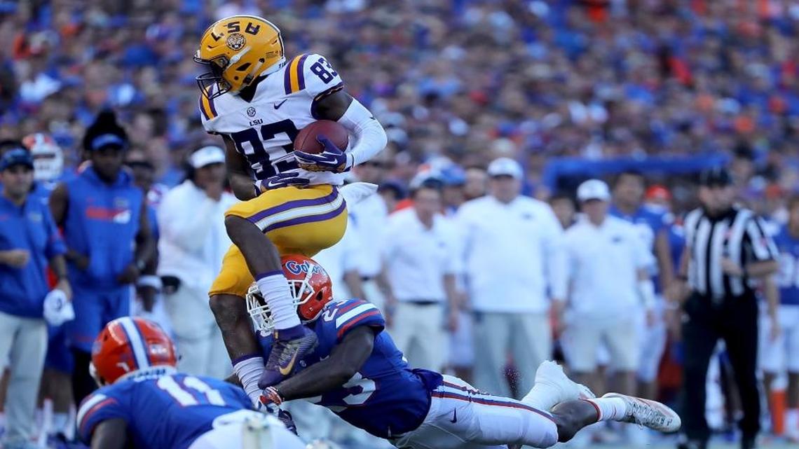 Russell Gage (83) of the LSU Tigers attempts to run past Chauncey Gardner Jr. #23 of the Florida Gators during the game at Ben Hill Griffin Stadium on October 7, 2017 in Gainesville, Florida.