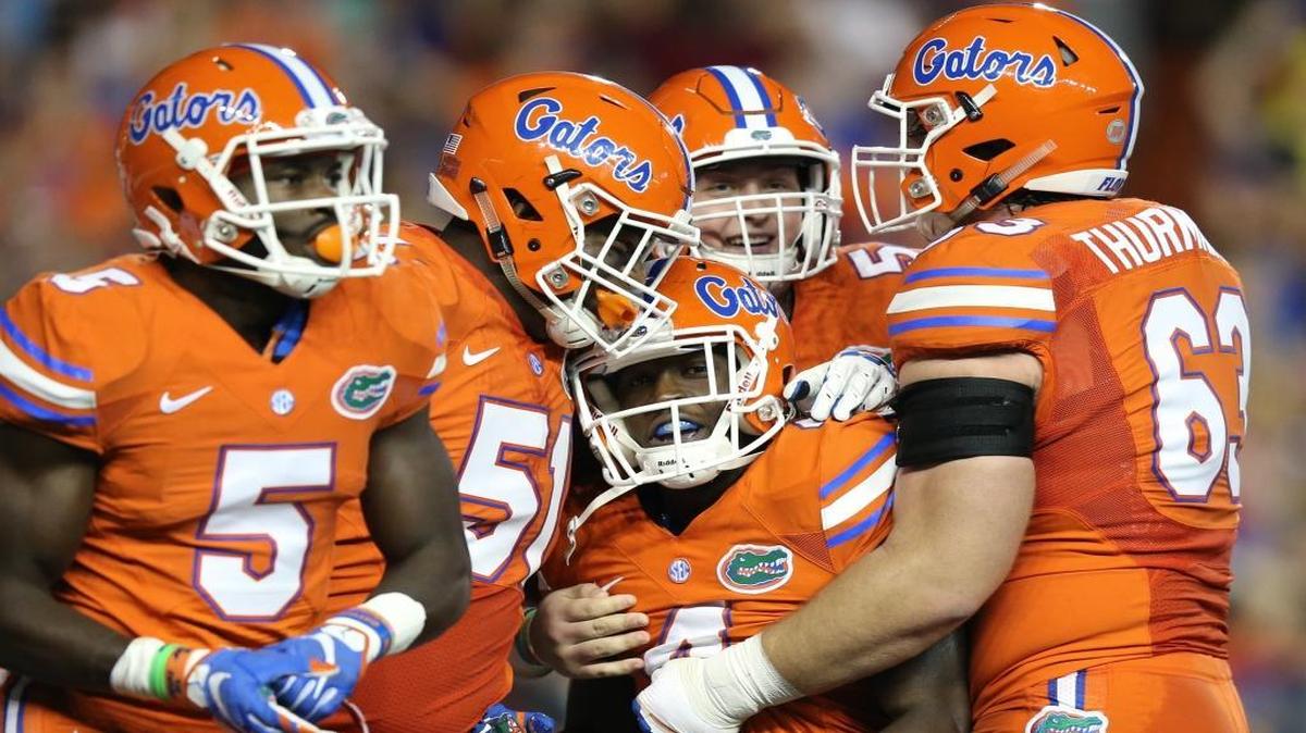 
Florida wide receiver Brandon Powell (4), center, is congratulated by teammates after scoring a 77-yard receiving touchdown during the first half of an NCAA college football game against Mississippi Saturday, Oct. 3, 2015, in Gainesville, Fla. 
