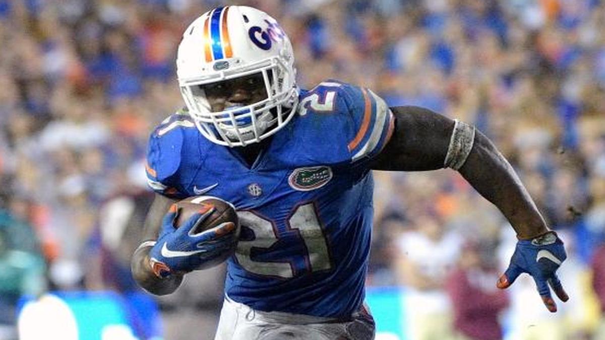 In this Nov. 28, 2015, file photo, Florida running back Kelvin Taylor (21) rushes for yardage during the second half of an NCAA college football game against Florida State in Gainesville, Fla. Florida coach Jim McElwain said Monday, Dec. 21, 2015, that running back Taylor, receiver Demarcus Robinson and defensive end Alex McCalister have decided to forgo their senior seasons and enter the NFL draft.