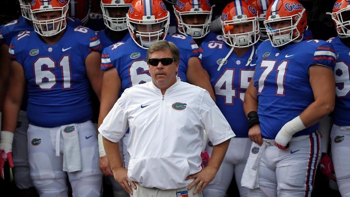 Florida head coach Jim McElwain, center, prepares to take the field with players before their game against Georgia on Saturday, Oct. 28, 2017, in Jacksonville.