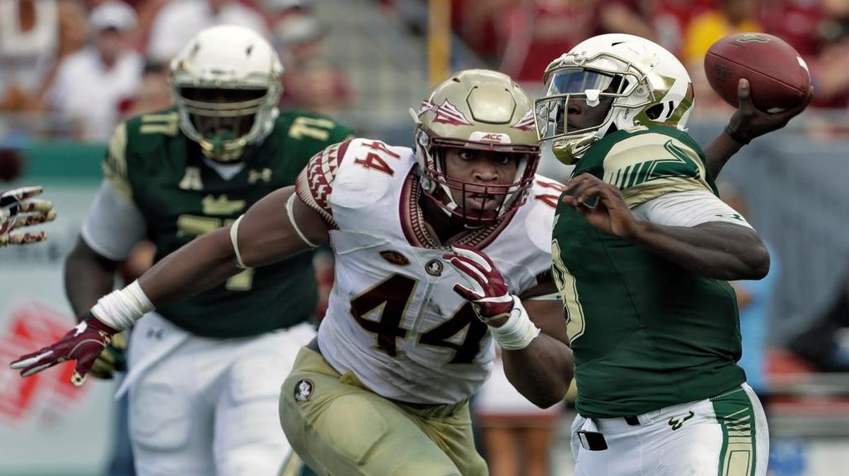 Florida State defensive end DeMarcus Walker (44) closes in on South Florida quarterback Quinton Flowers as he throws a pass during the second half of an NCAA college football game, in Tampa, Fla. The 6-4, 280-pound DE leads the nation with 10.5 sacks to match his total from last year and has three forced fumbles.