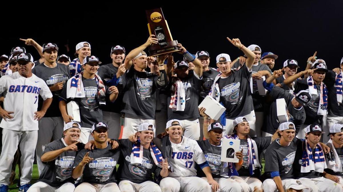 Florida players celebrate with the trophy after defeating LSU in Game 2 to win the NCAA College World Series baseball finals in Omaha, Neb., Tues., June 27, 2017.