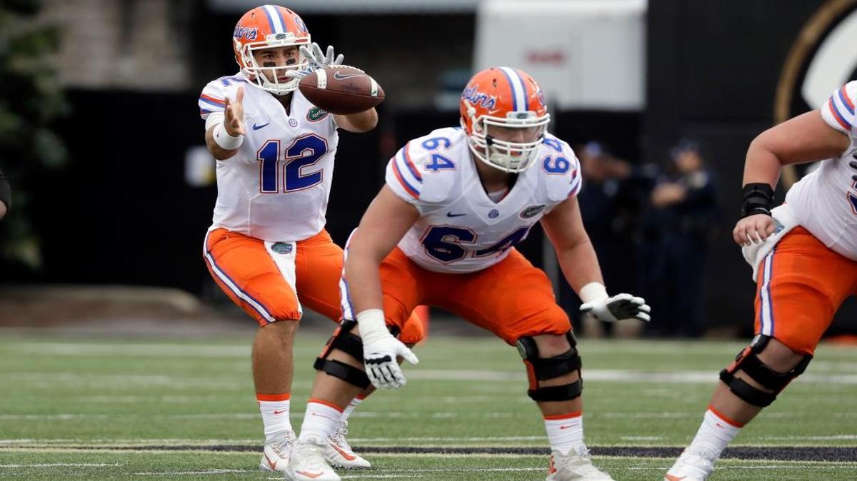 Florida quarterback Austin Appleby (12) takes a snap as offensive lineman Tyler Jordan (64) blocks in the first half of an NCAA college football game Vanderbilt Sat., Oct. 1, 2016, in Nashville, Tenn.