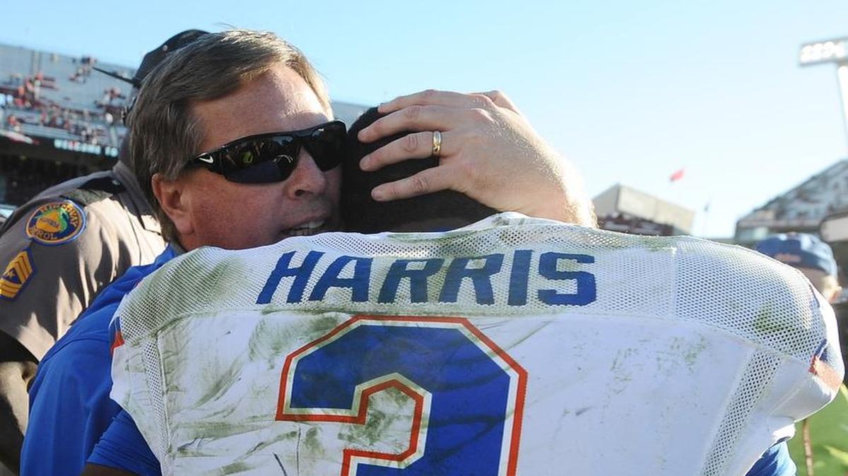 Florida head coach Jim McElwain, left, embraces quarterback Treon Harris after defeating South Carolina 24-14 on Saturday, Nov. 14, 2015, in Columbia, S.C.