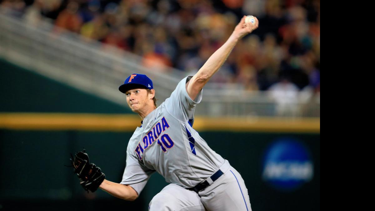 
Florida pitcher A.J. Puk (10) delivers against Virginia in the fifth inning of an NCAA College World Series baseball game at TD Ameritrade Park in Omaha, Neb., Monday, June 15, 2015. 
