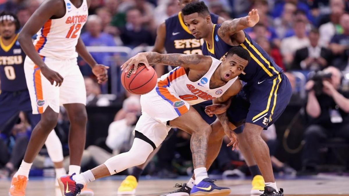 Kasey Hill #0 of the Florida Gators runs into Jermaine Long #24 of the East Tennessee State Buccaneers during the first round of the 2017 NCAA Men's Basketball Tournament at Amway Center on March 16, 2017 in Orlando, Florida.
