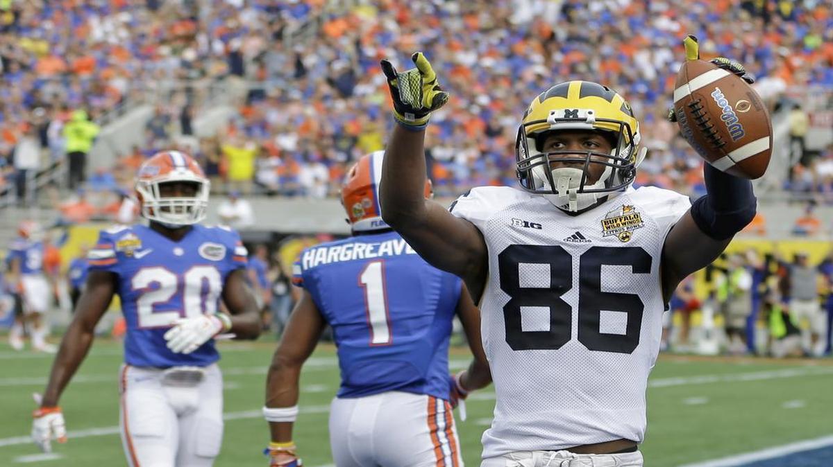 Michigan wide receiver Jehu Chesson (86) celebrates his 31-yard reception for a touchdown as Florida defensive back Vernon Hargreaves III (1) and defensive back Marcus Maye (20) walk off the field during the first half of the Citrus Bowl NCAA college football game, Friday, Jan. 1, 2016, in Orlando, Fla.
