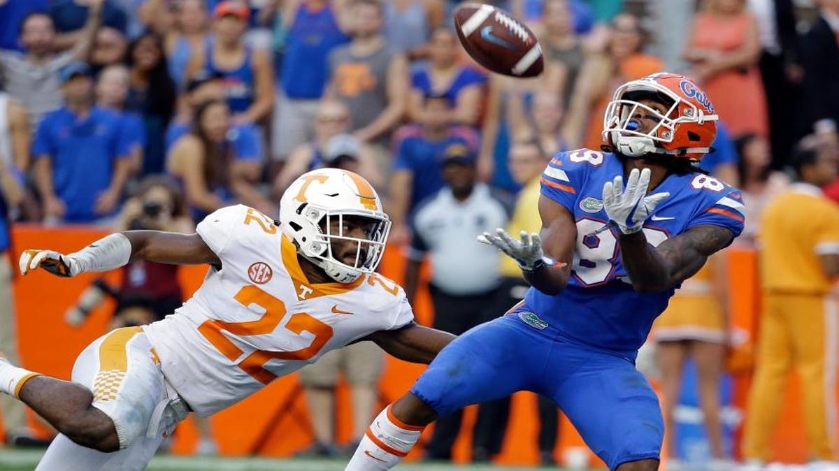 Florida wide receiver Tyrie Cleveland, right, catches the game winning 63-yard touchdown pass in front of Tennessee defensive back Micah Abernathy (22) as time expired in the fourth quarter of an NCAA college football game, Saturday, Sept. 16, 2017, in Gainesville, Fla. Florida won 26-20.