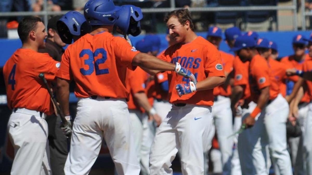 Florida freshman Austin Langworthy (44) celebrates with Keenan Bell and Mike Rivera after hitting his first career home run during the Gators' 11-6 win over William & Mary on Feb. 19, 2017, at McKethan Stadium.