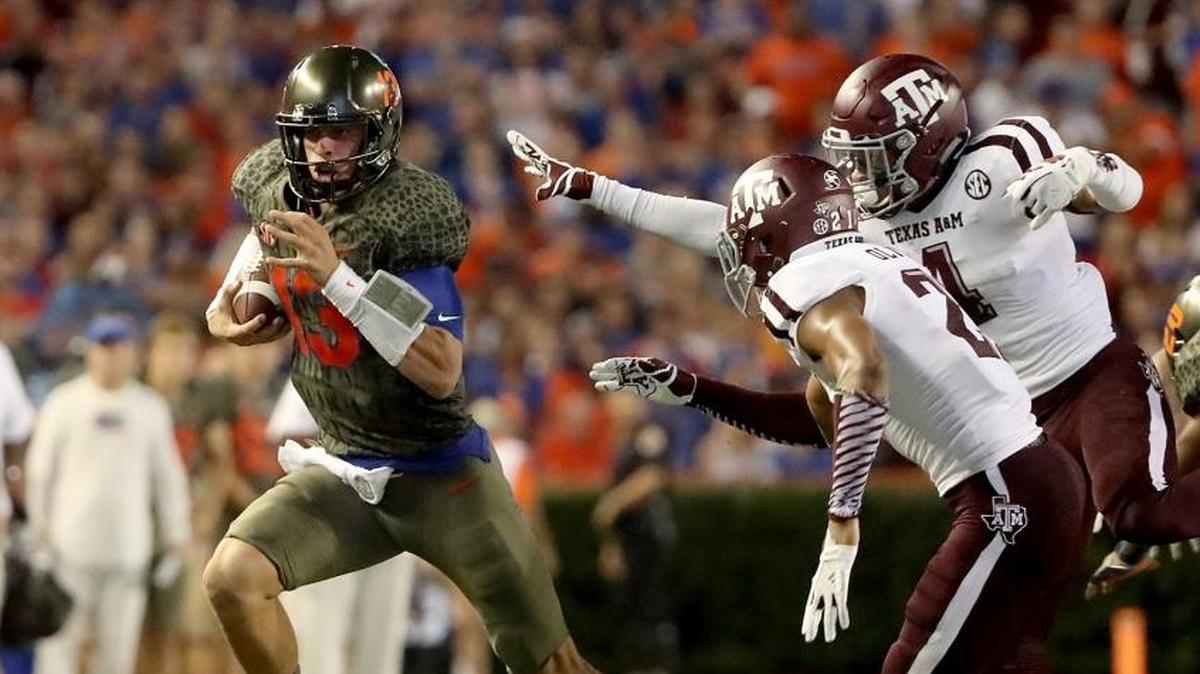 Florida quarterback Feleipe Franks runs past Texas A&M defenders during the 19-17 loss to the Aggies.