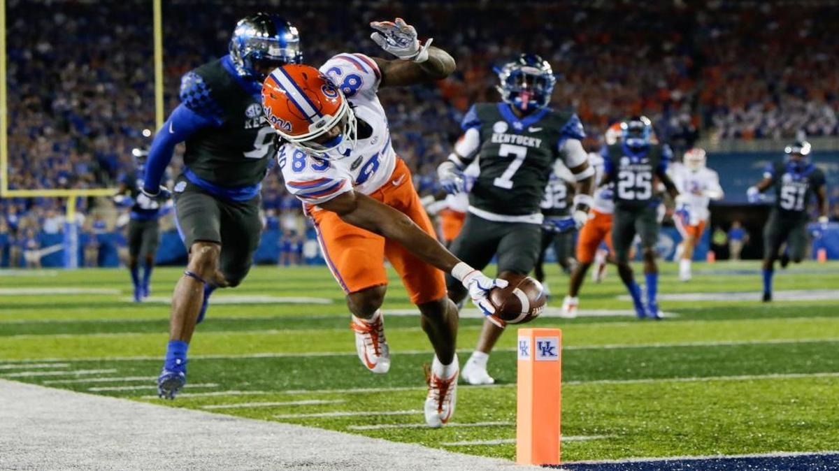 Florida wide receiver Tyrie Cleveland reaches for the goal line in front of Kentucky cornerback Derrick Baity, left, and safety Mike Edwards to score a touchdown during the first half of an NCAA college football game Sat., Sept. 23, 2017, in Lexington, Ky.