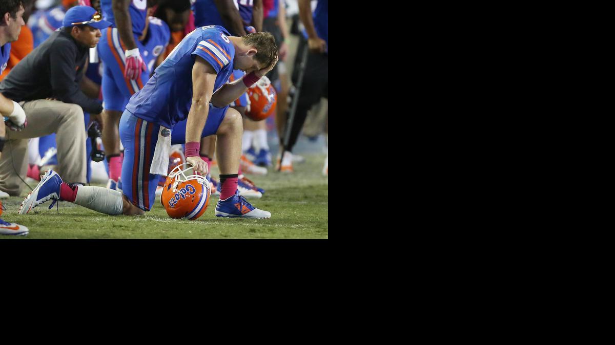 
Florida quarterback Jeff Driskel is dejected as Louisiana State kicker Colby Delahoussaye kicks a 50-yard field goal with :03 to play at Ben Hill Griffin Stadium in Gainesville on Oct. 11, 2014. LSU won, 30-27.
