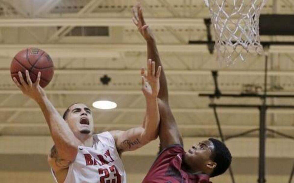 
Barry University’s Yunio Barrueta is fouled by Indianapolis’ Joe Lawson during the first half in Miami on Tuesday, Dec. 16, 2014.

