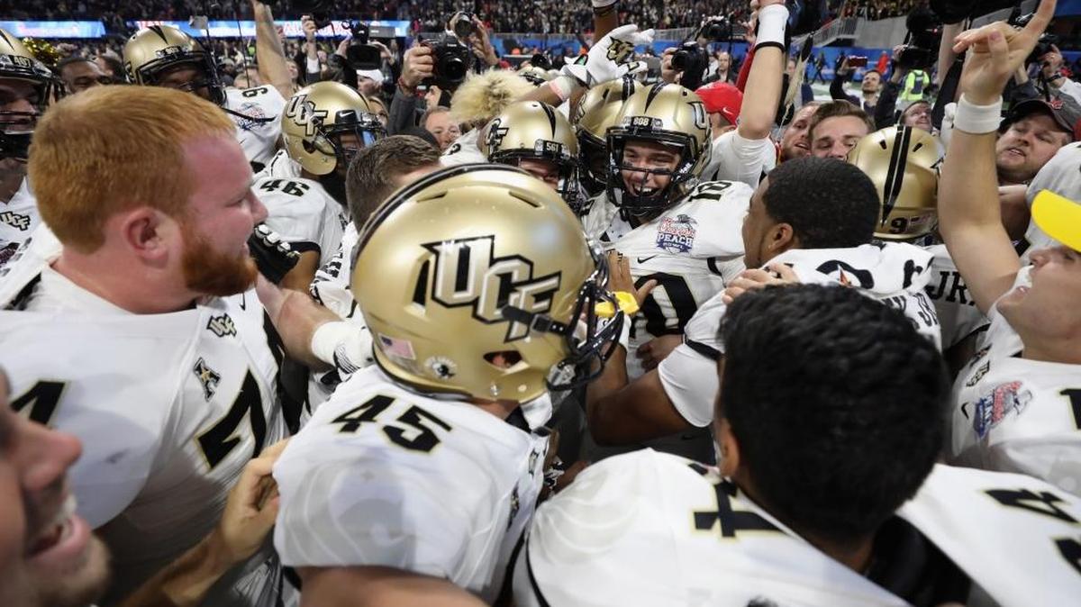 The UCF Knights celebrate defeating the Auburn Tigers 34-27 to win the Chick-fil-A Peach Bowl at Mercedes-Benz Stadium on January 1, 2018 in Atlanta.