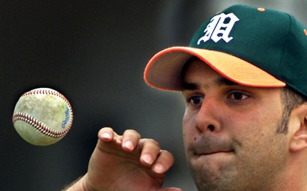 
University of Miami shortstop Javy Rodriguez juggles a ball during practice at Mark Light Stadium.
